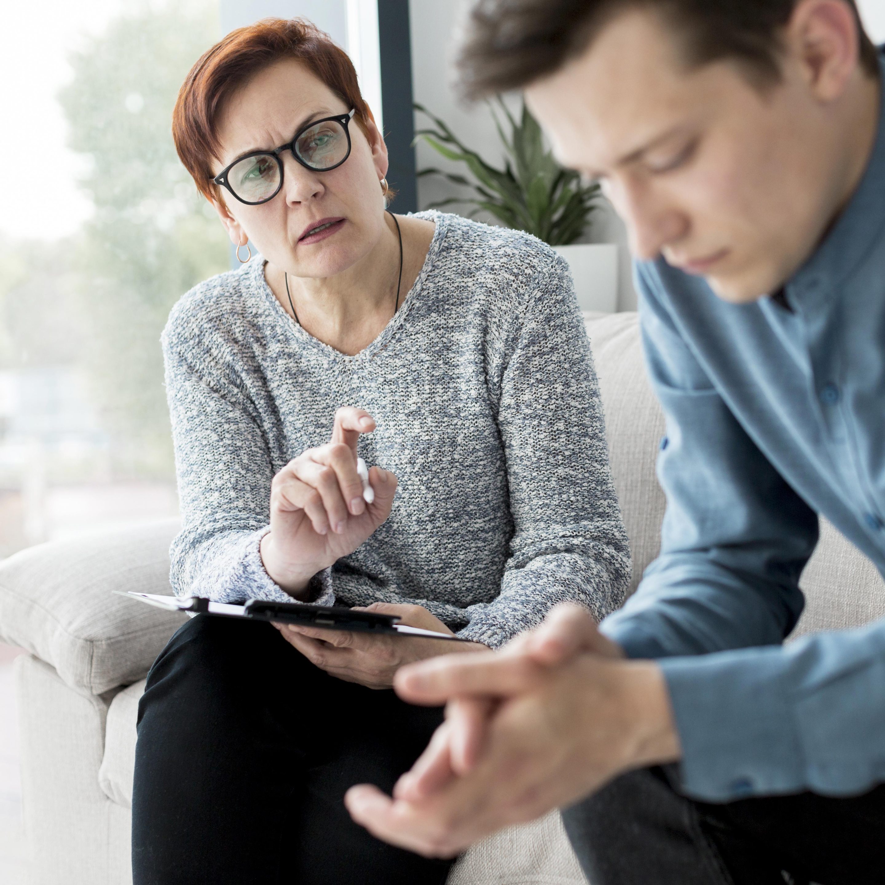 Depression counseling session with a therapist supporting an adult client